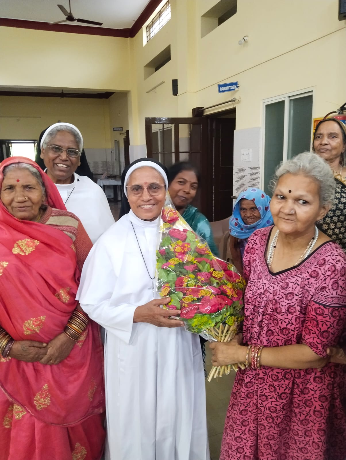 Residents of Dayadham interacting in a garden